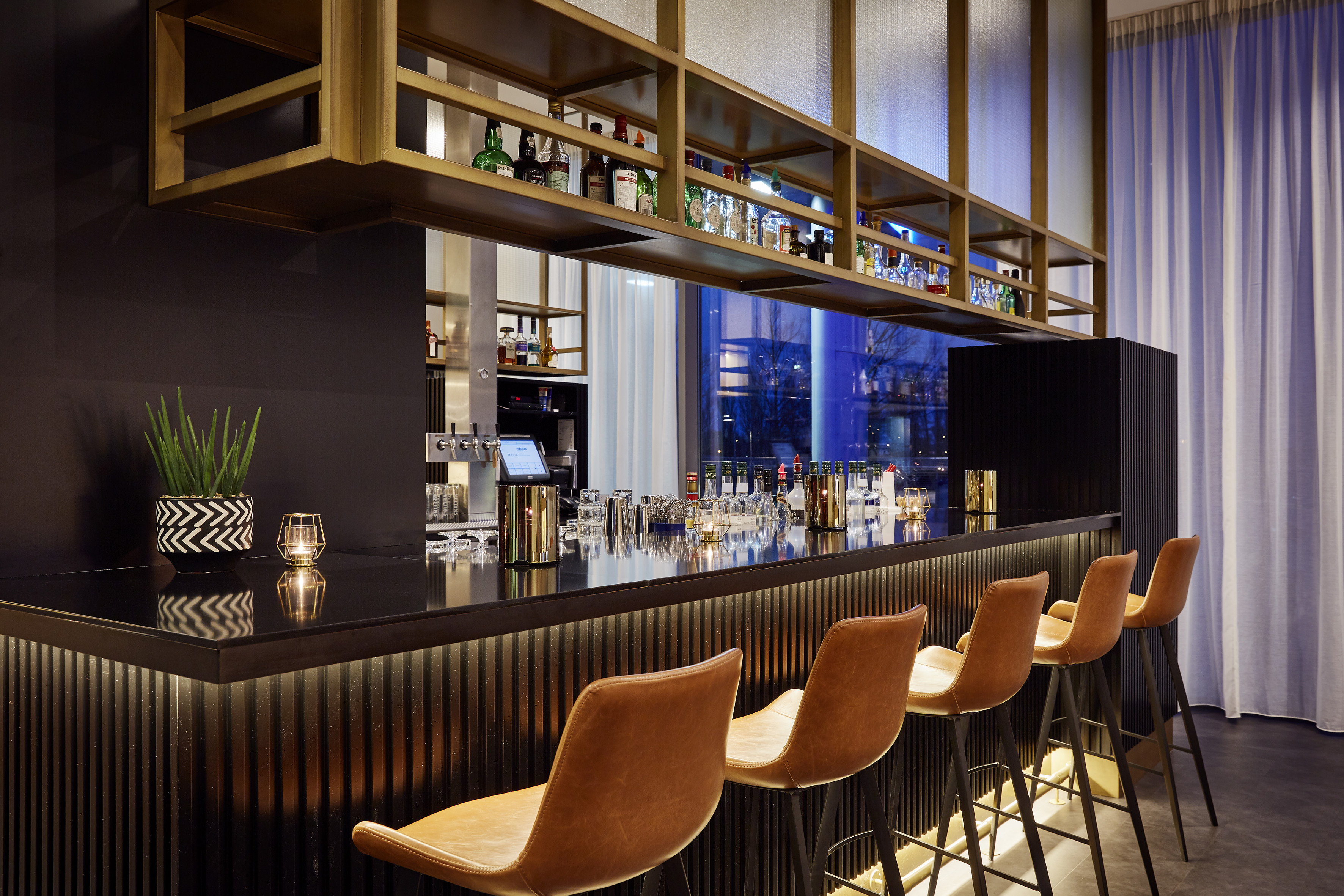 a bar with chairs and a shelf
