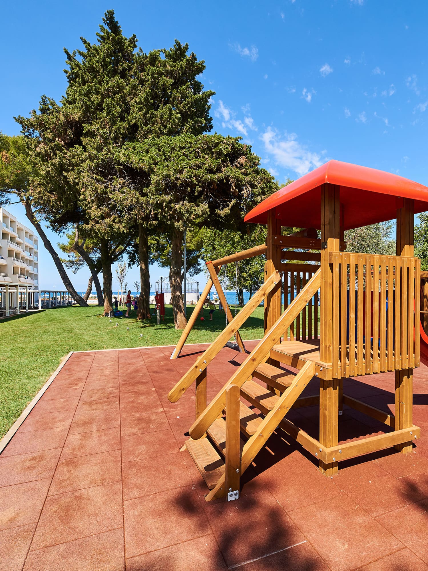 a playground with a slide and trees in the background