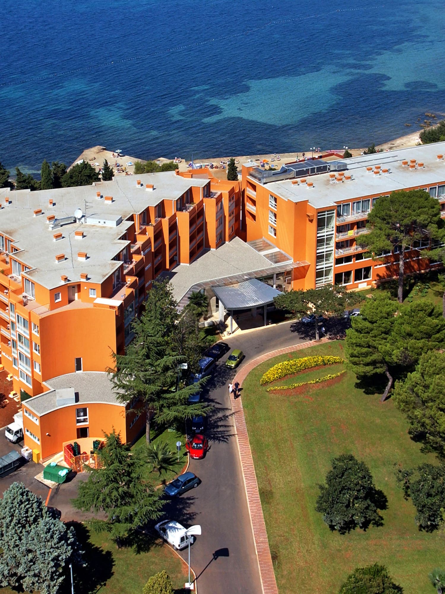 an orange building next to a body of water