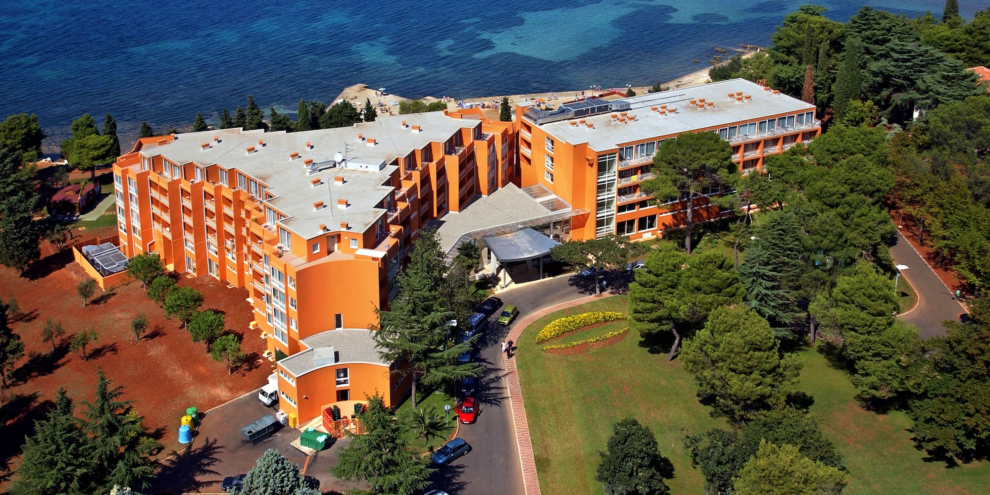 an orange building next to a body of water