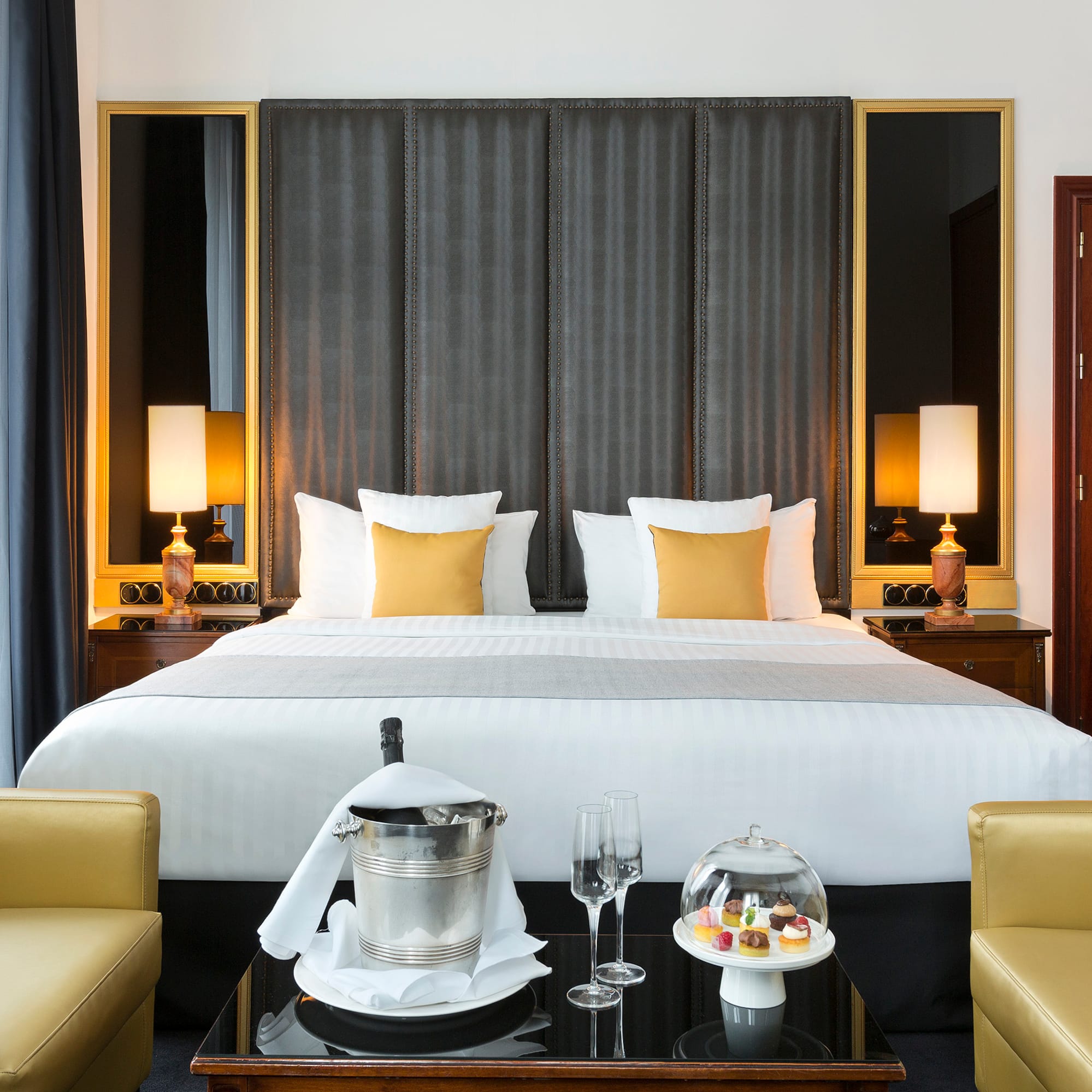 a hotel room with a bed and chairs