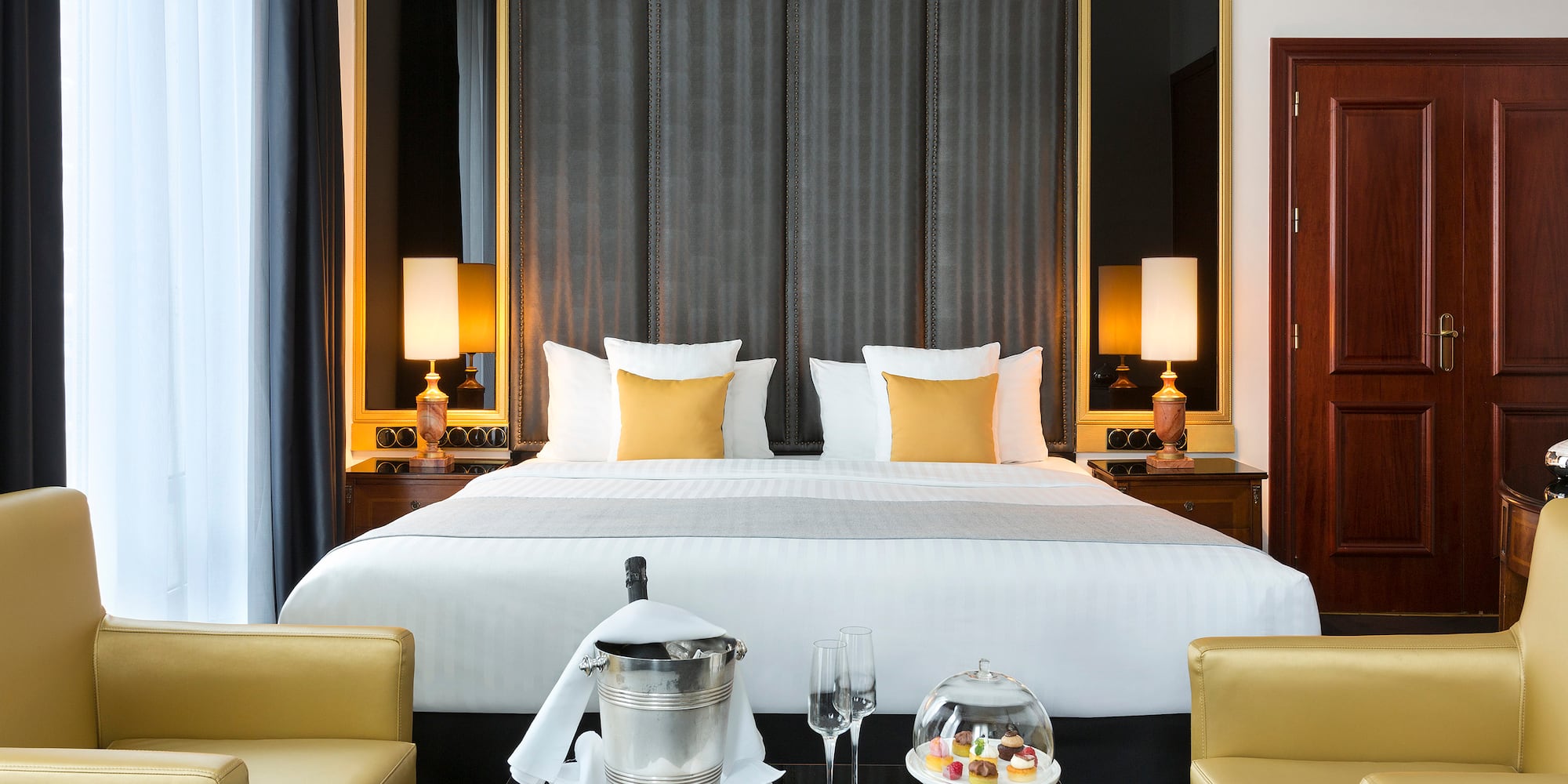 a hotel room with a bed and chairs