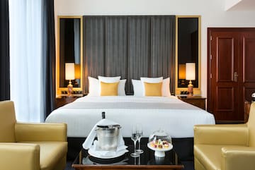 a hotel room with a bed and chairs