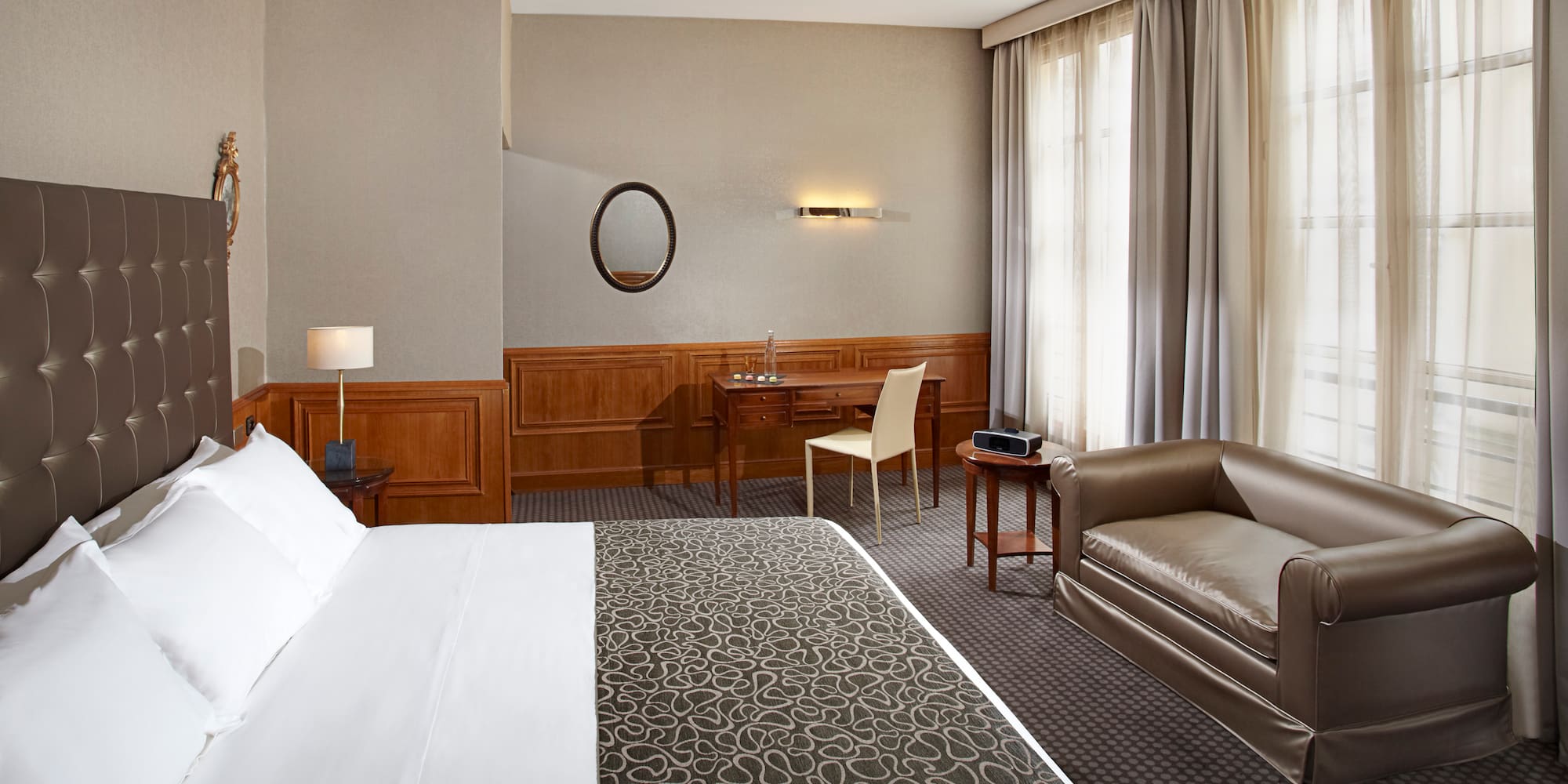 a hotel room with a bed and a chair