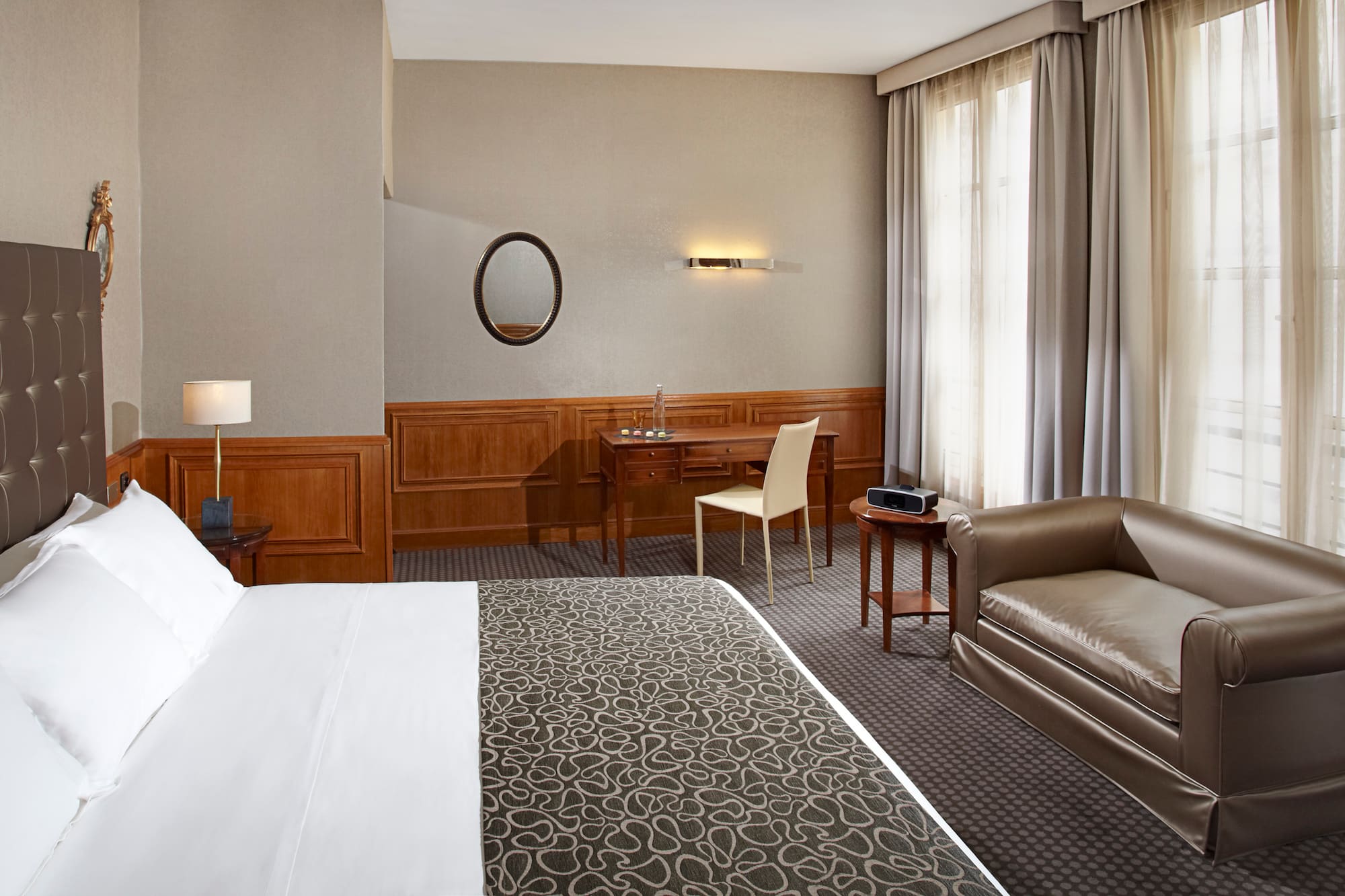 a hotel room with a bed and a chair