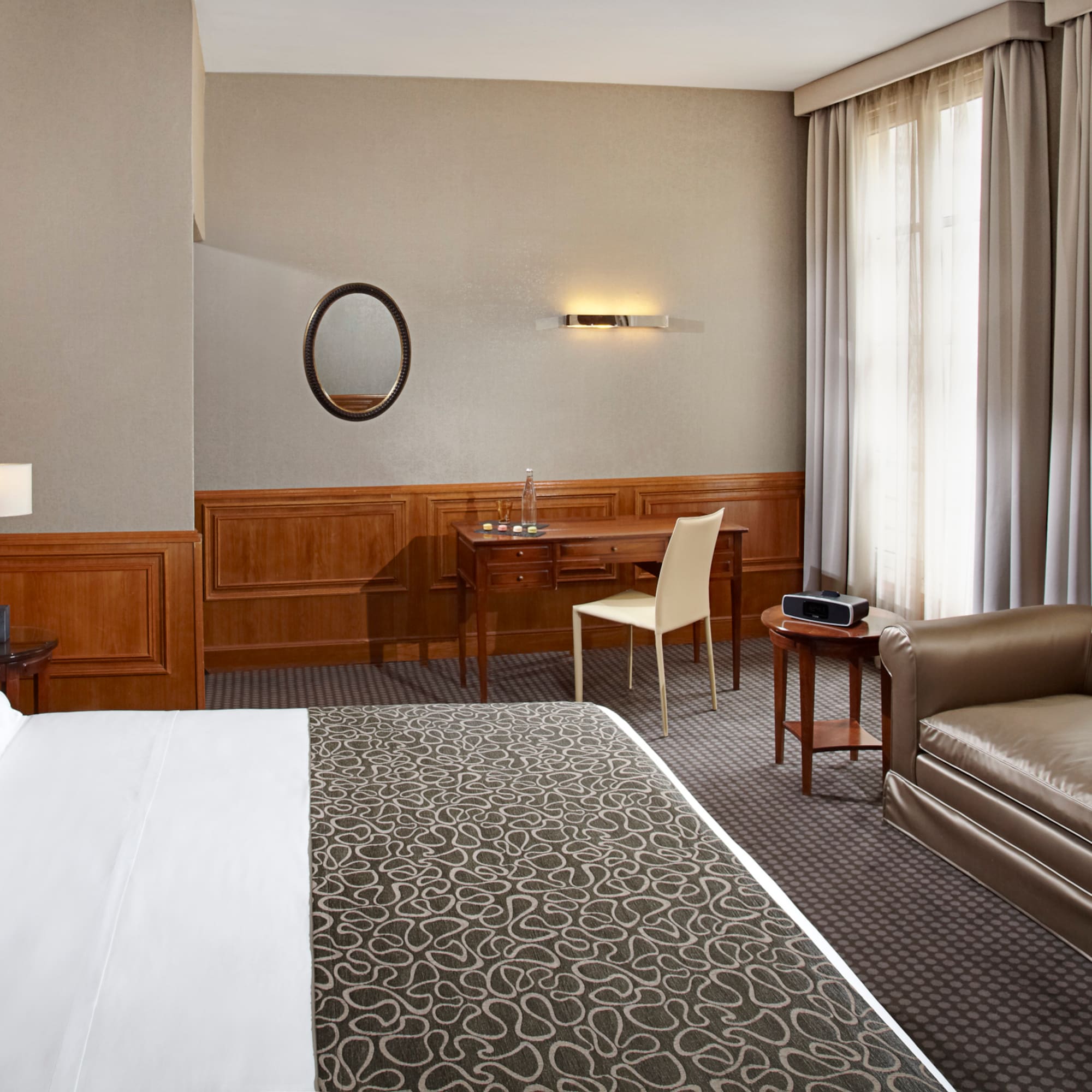 a hotel room with a bed and a chair