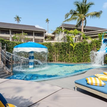 a pool with a water slide and a slide