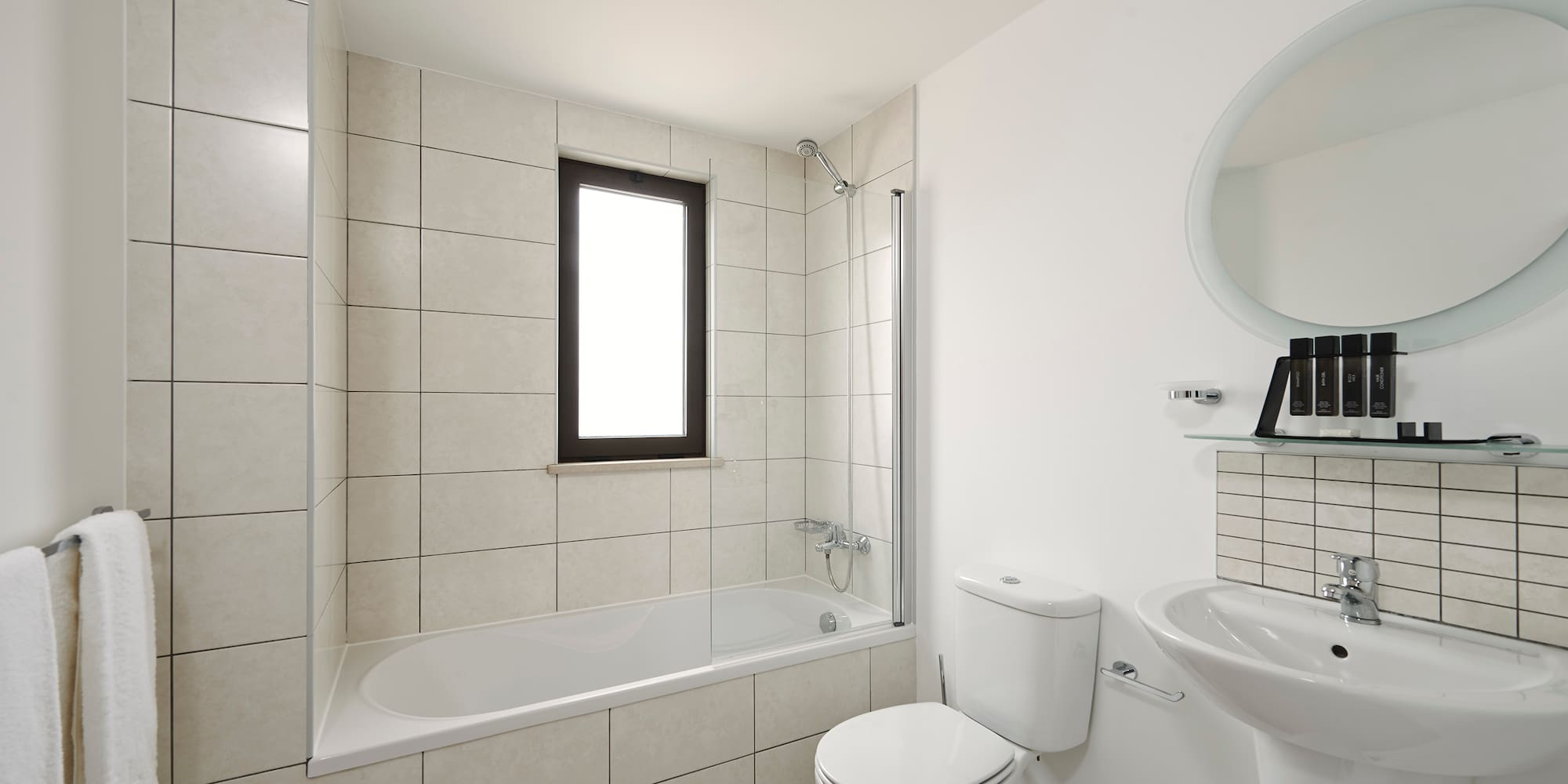 a bathroom with a tub and toilet