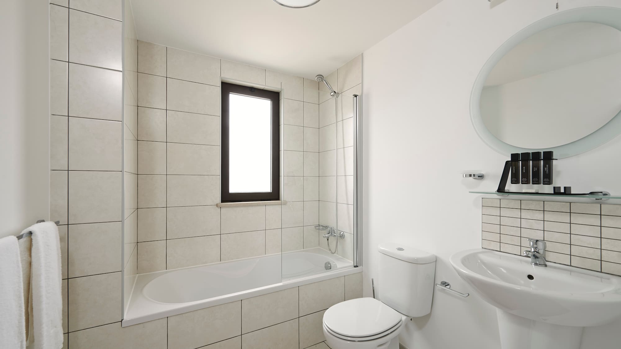 a bathroom with a tub and toilet