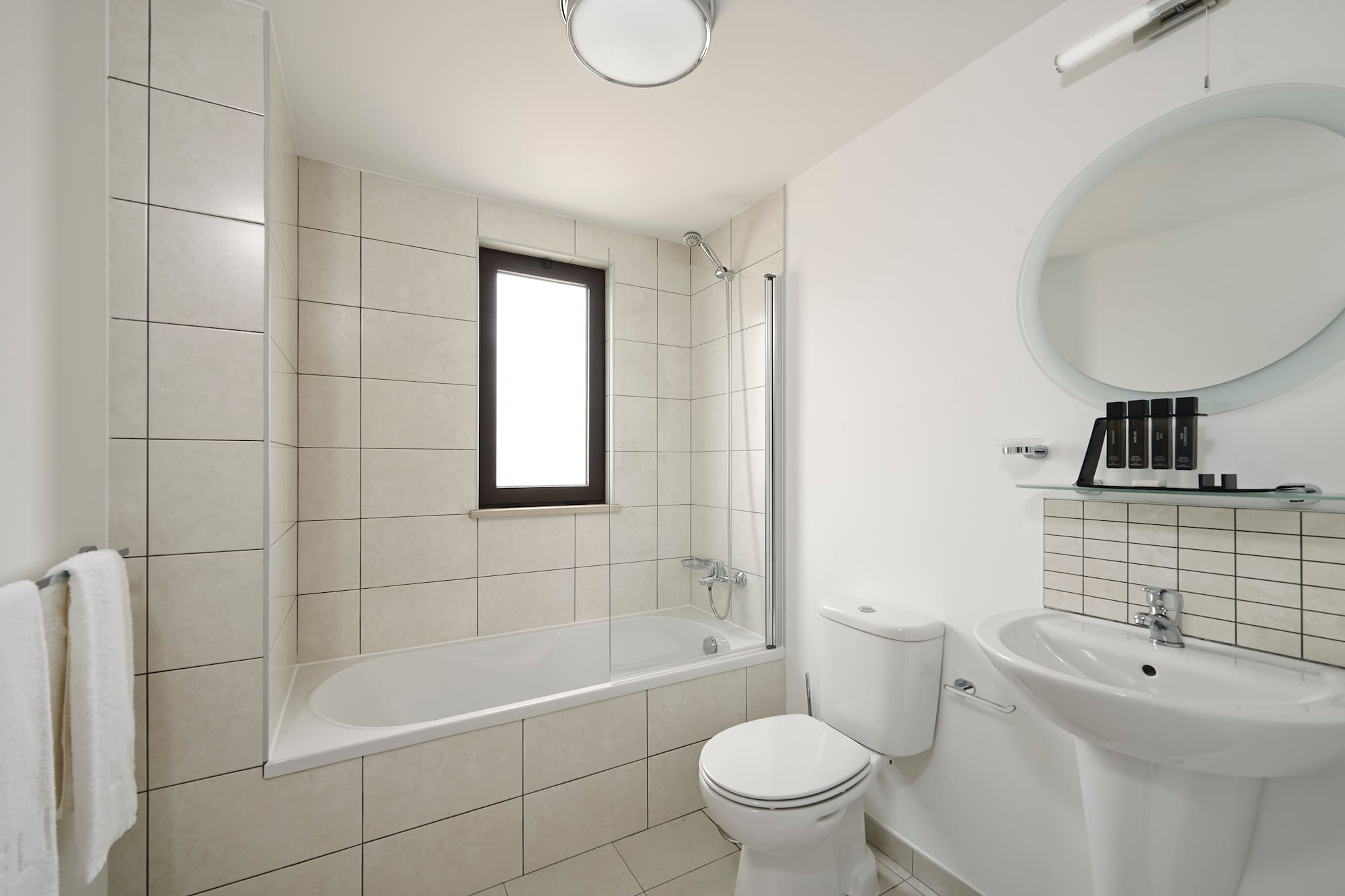 a bathroom with a tub and toilet