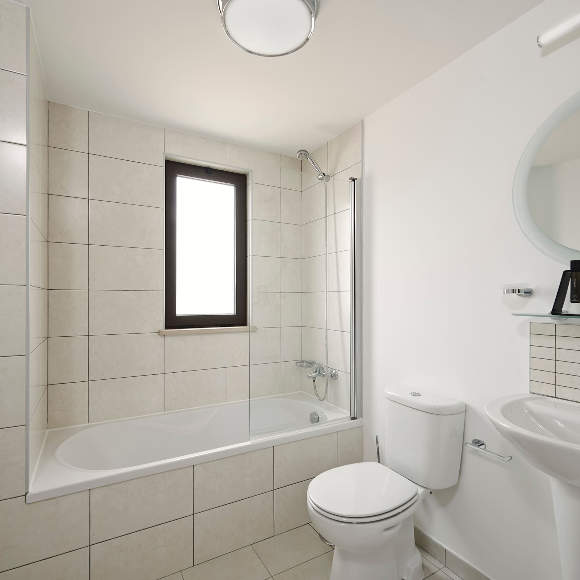 a bathroom with a tub and toilet