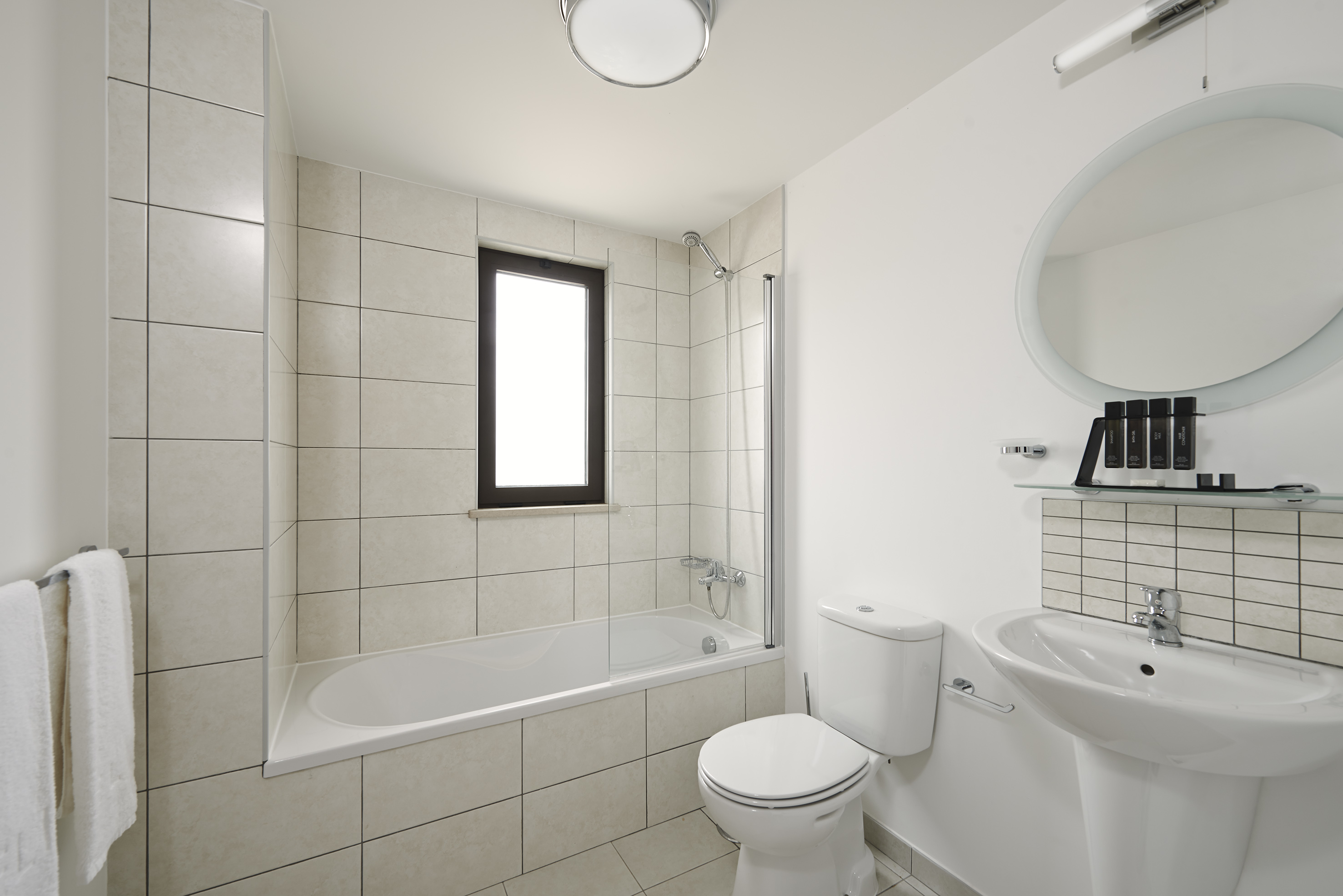 a bathroom with a tub and toilet