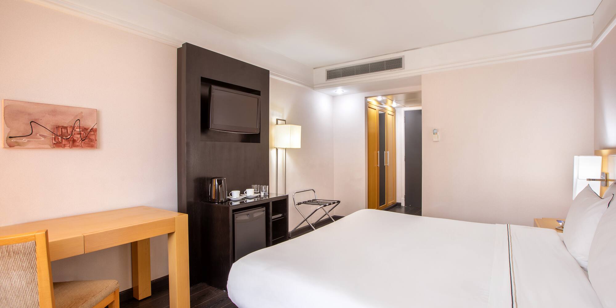 a room with a bed and a television