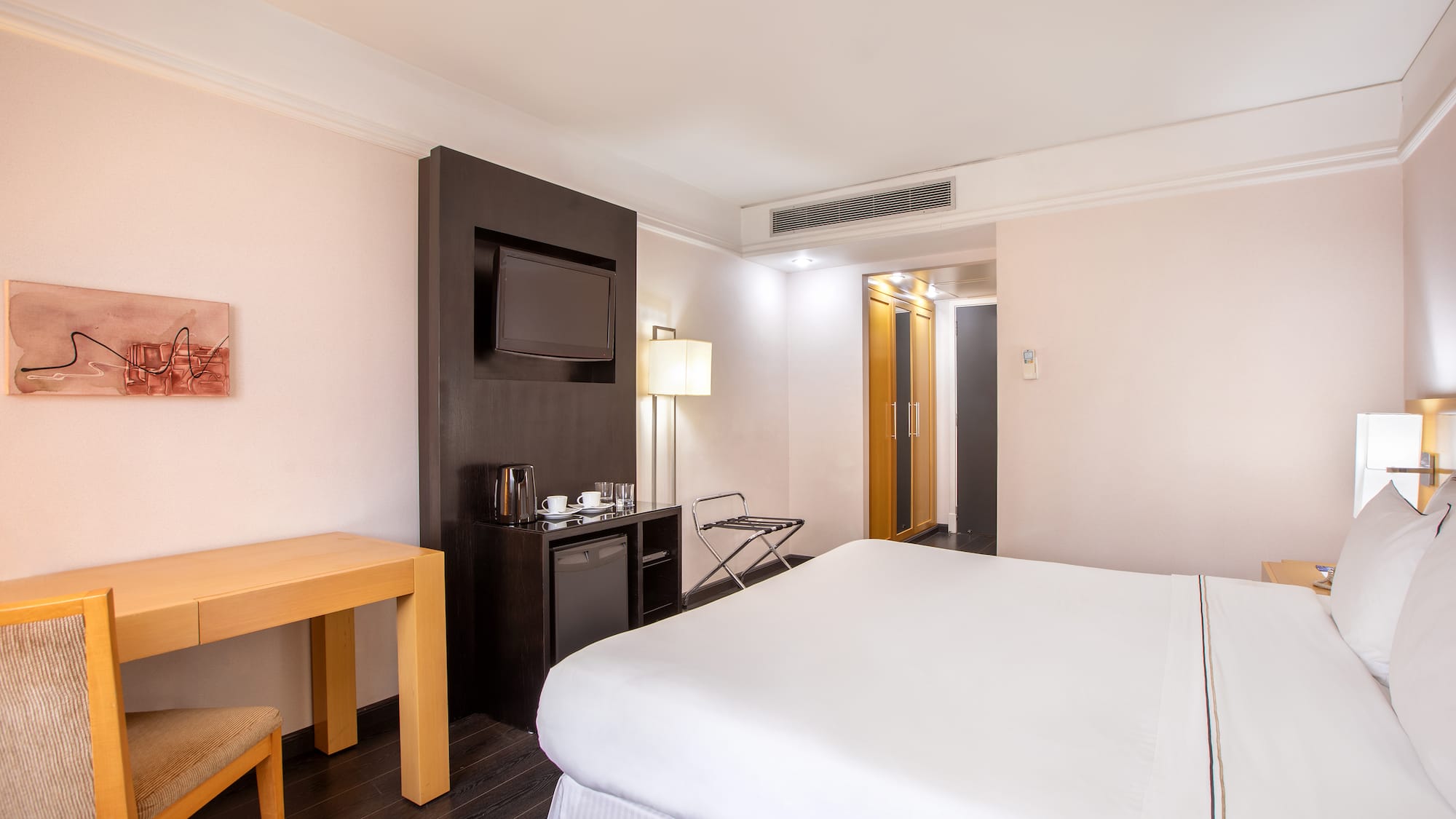 a room with a bed and a television