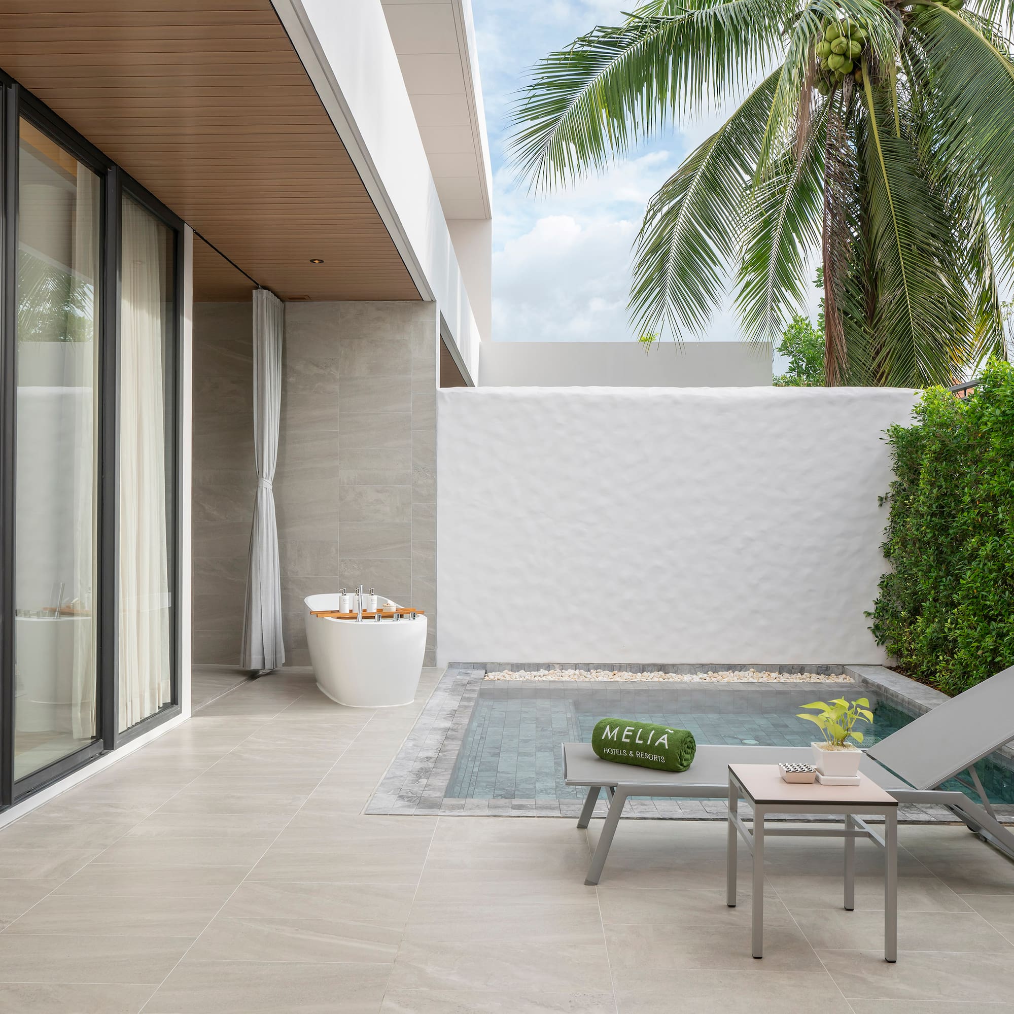 a pool and lounge chair in a backyard