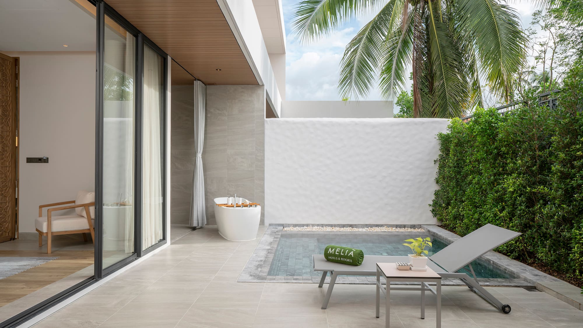 a pool and lounge chair in a backyard