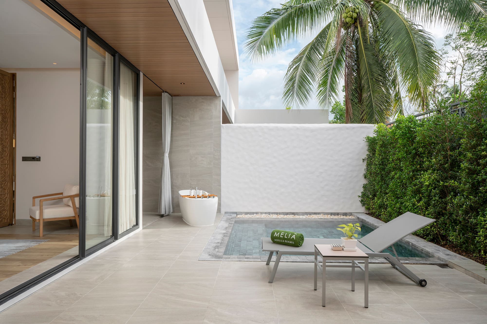 a pool and lounge chair in a backyard