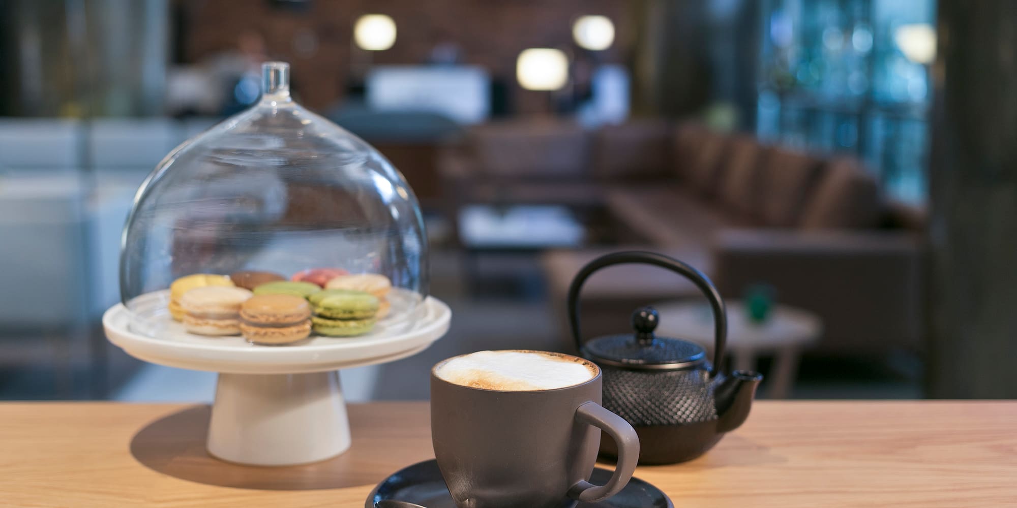 a cup of coffee and a teapot on a table