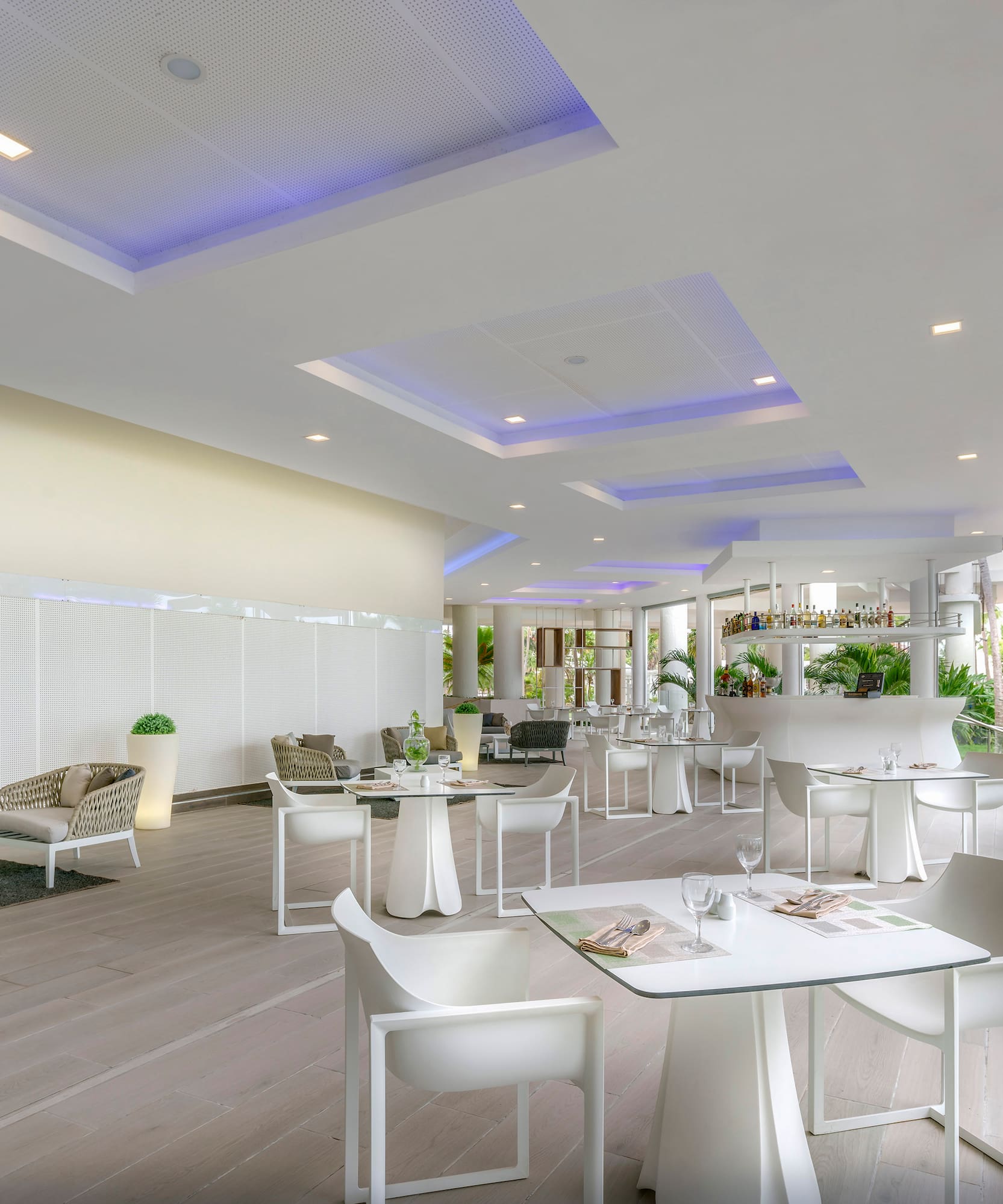 a room with white tables and chairs