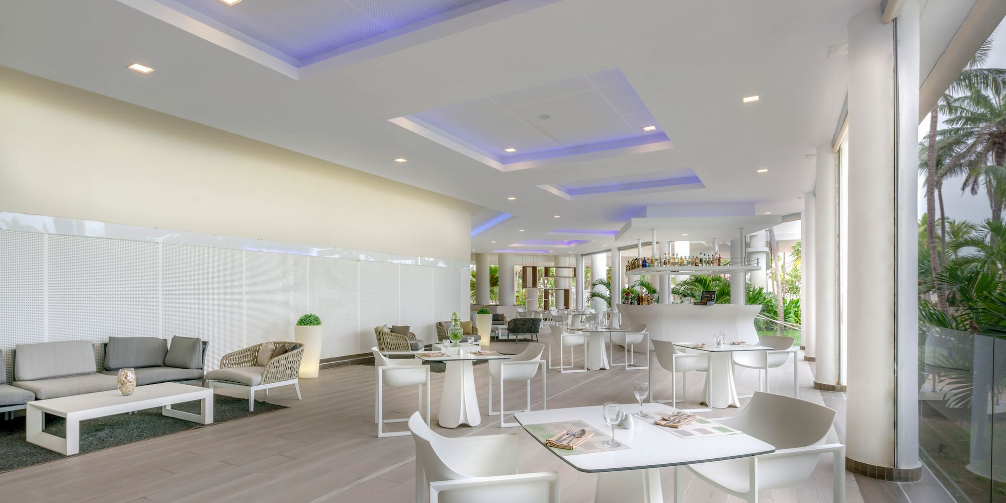 a room with white tables and chairs