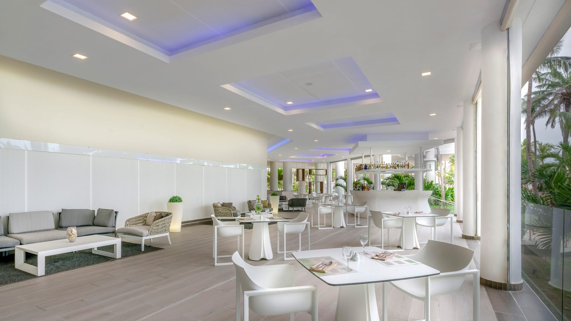 a room with white tables and chairs