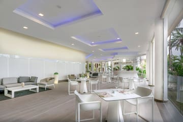 a room with white tables and chairs