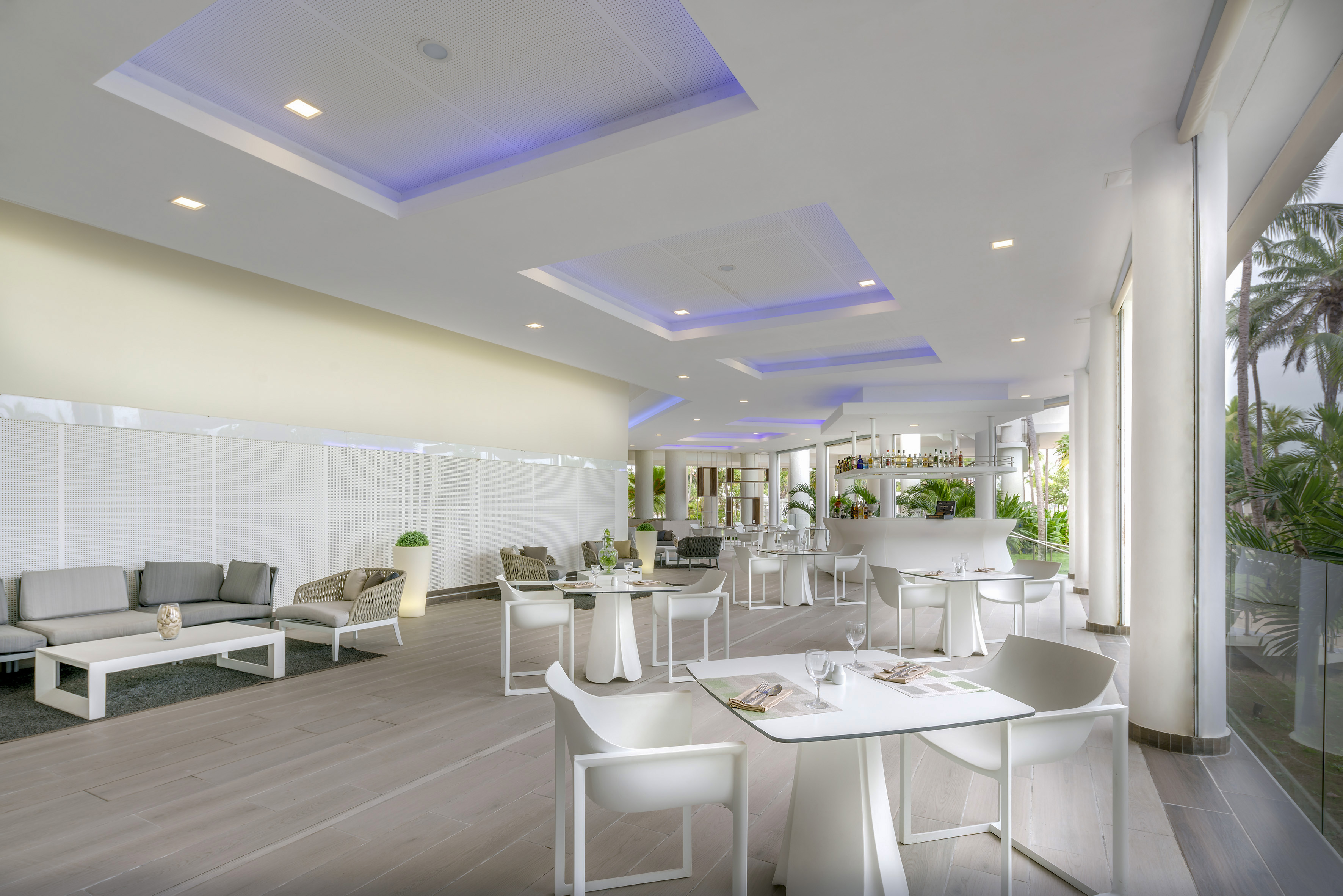 a room with white tables and chairs