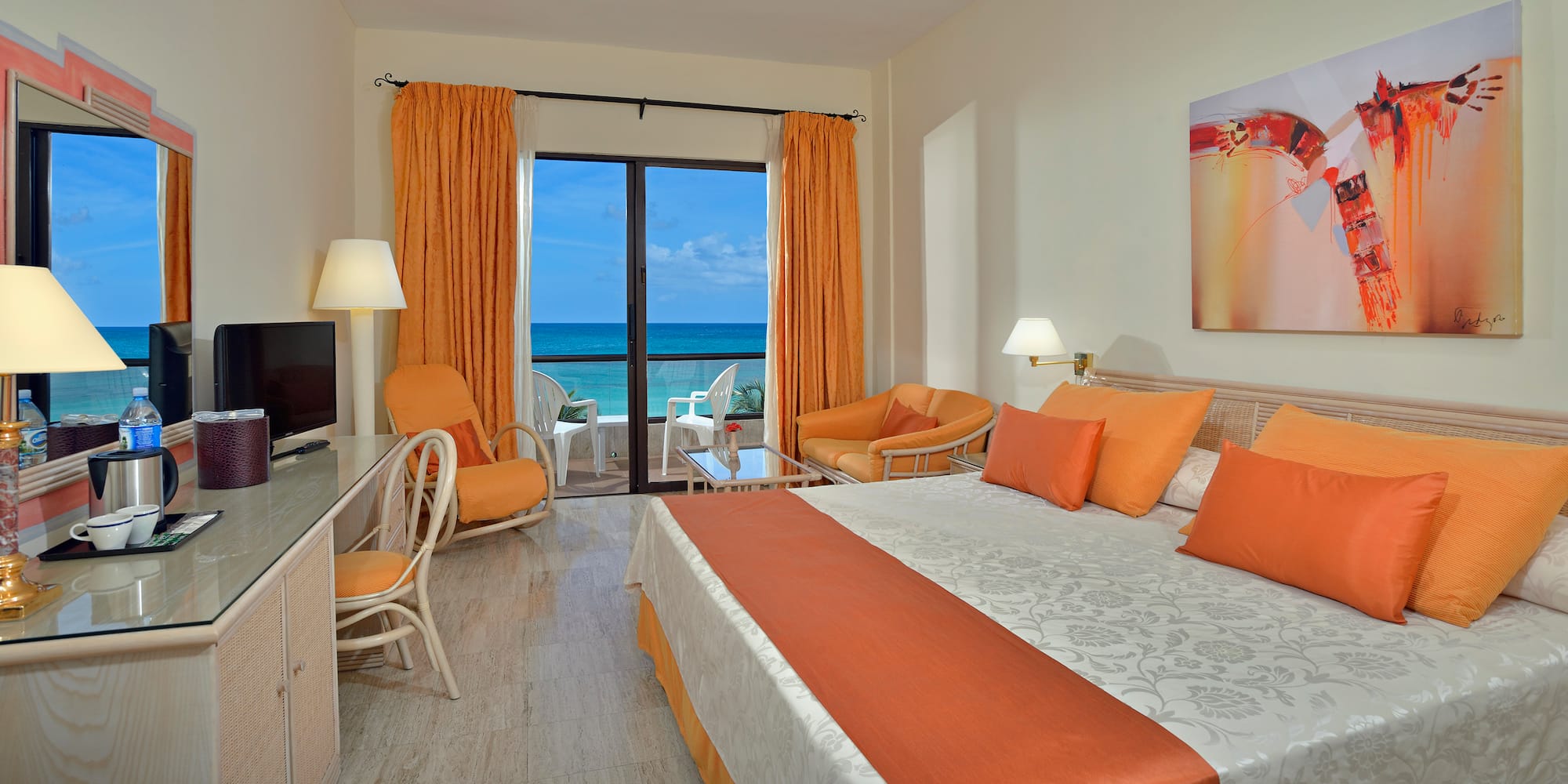 a room with a bed and chairs and a table