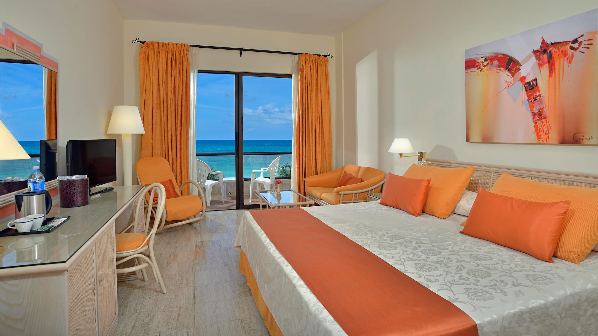 a room with a bed and chairs and a table