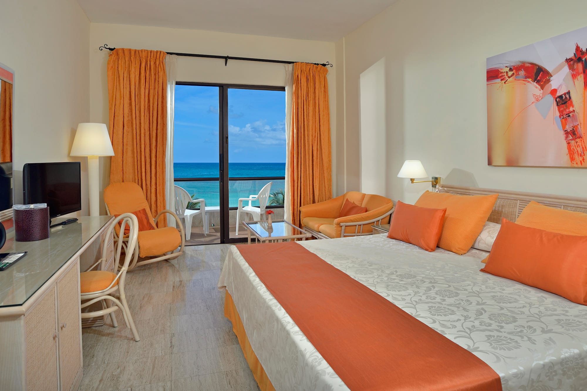 a room with a bed and chairs and a table