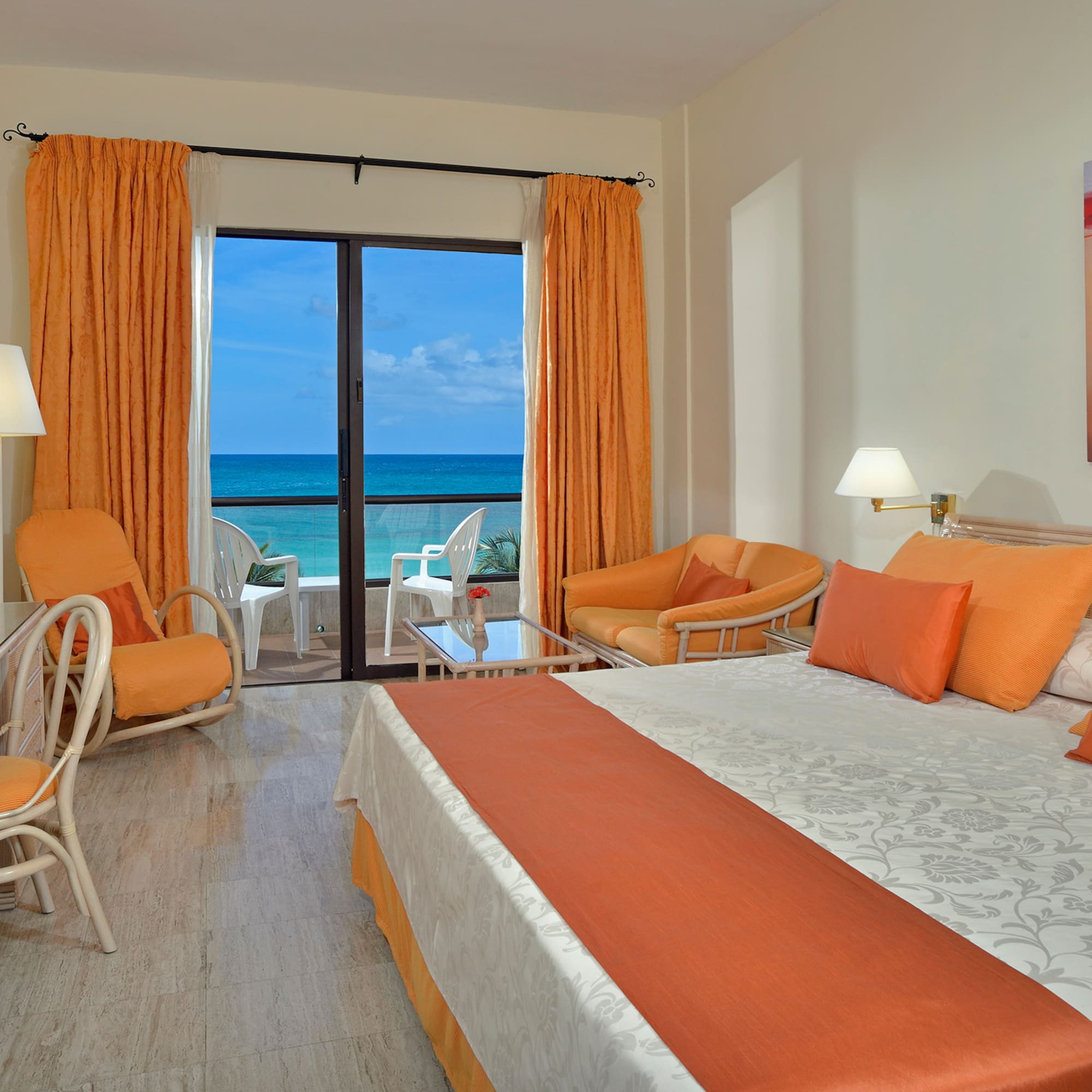 a room with a bed and chairs and a table