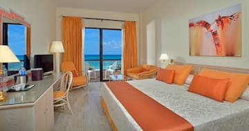 a room with a bed and chairs and a table