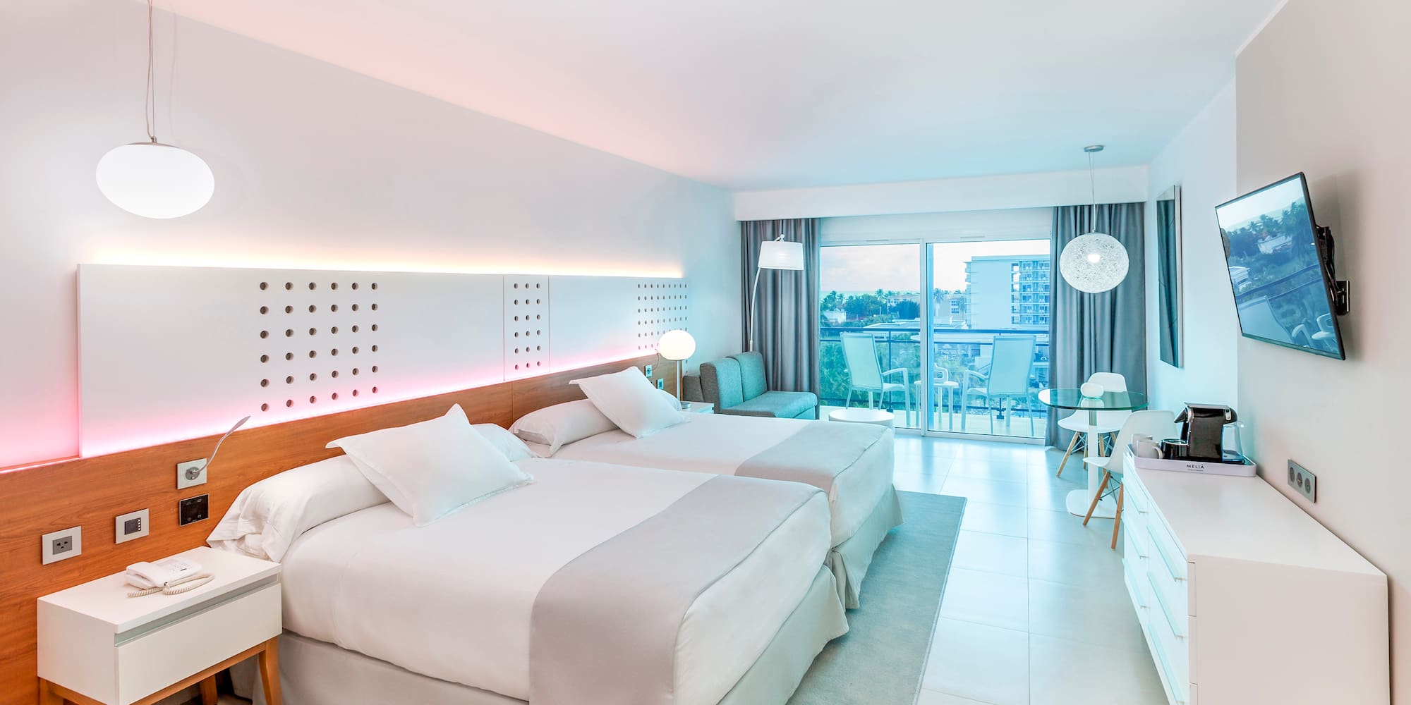 a room with two beds and a table