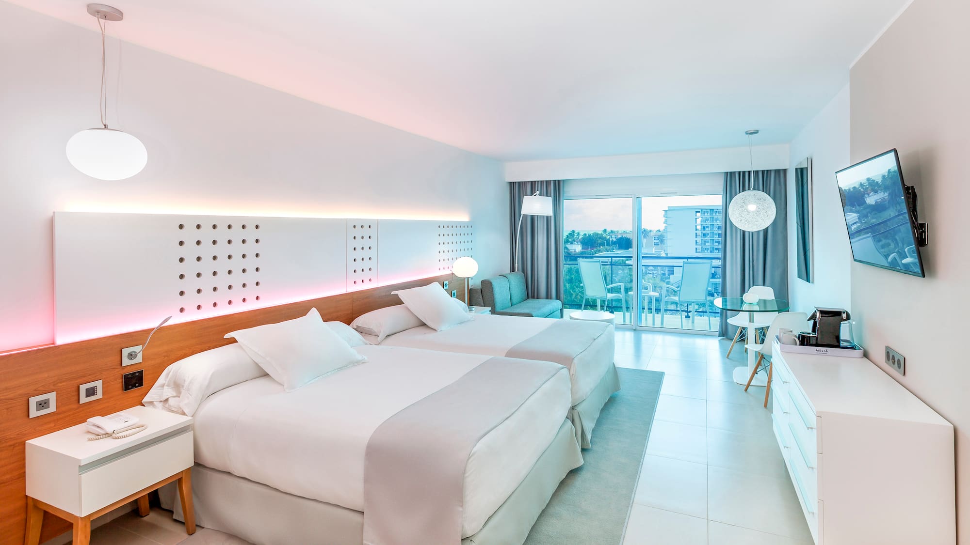 a room with two beds and a table