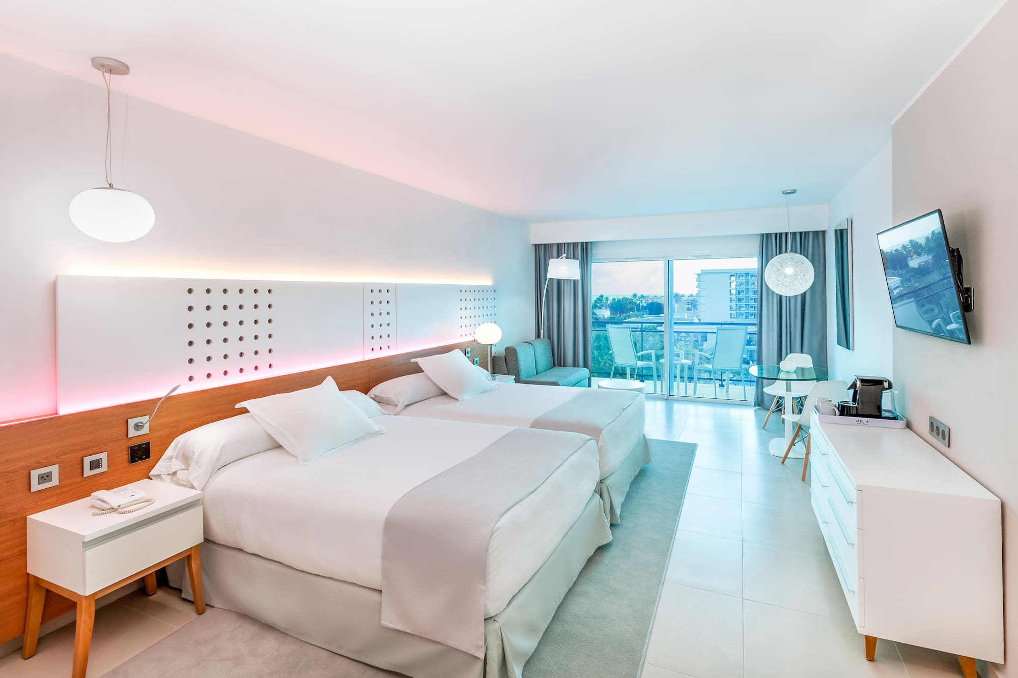 a room with two beds and a table