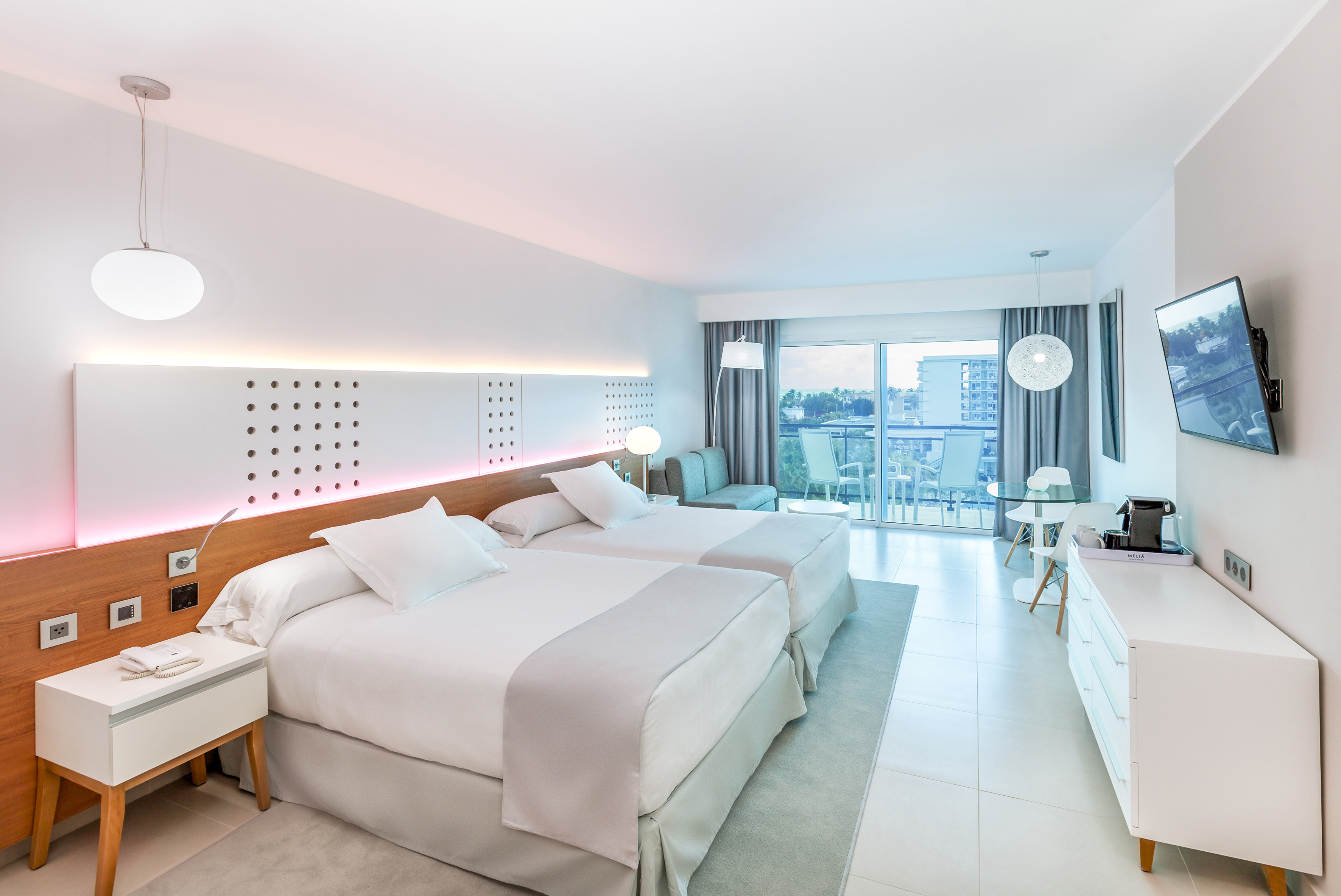 a room with two beds and a table