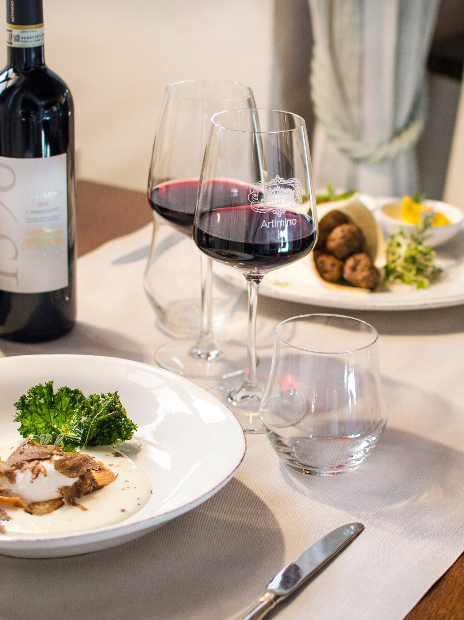 a table with wine glasses and food on it