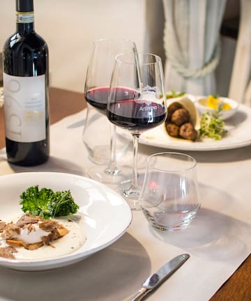 a table with wine glasses and food on it