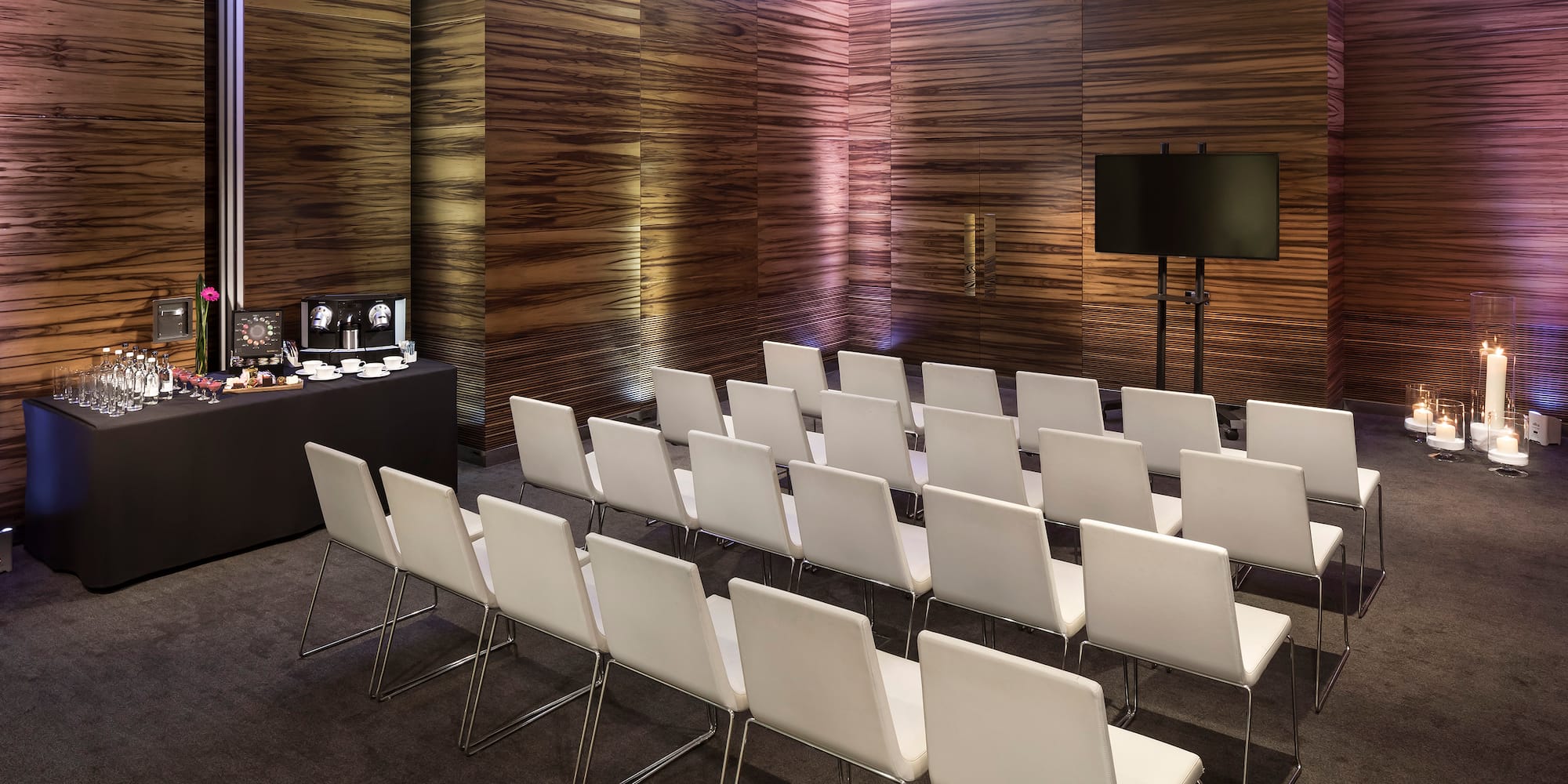 a room with white chairs and a table