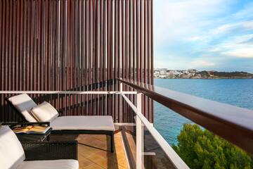 a balcony with a view of the water and a city