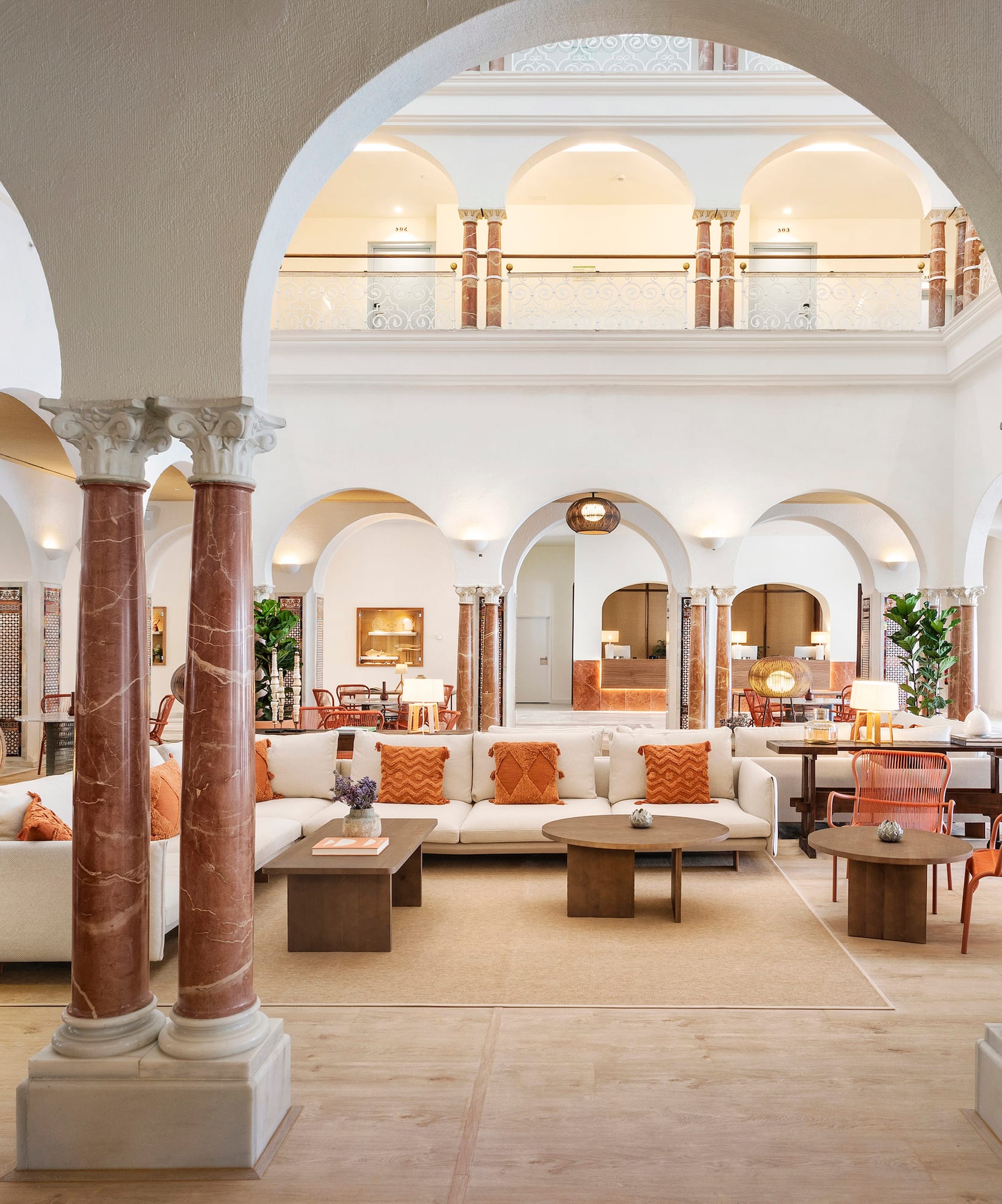 a large white room with columns and a couch