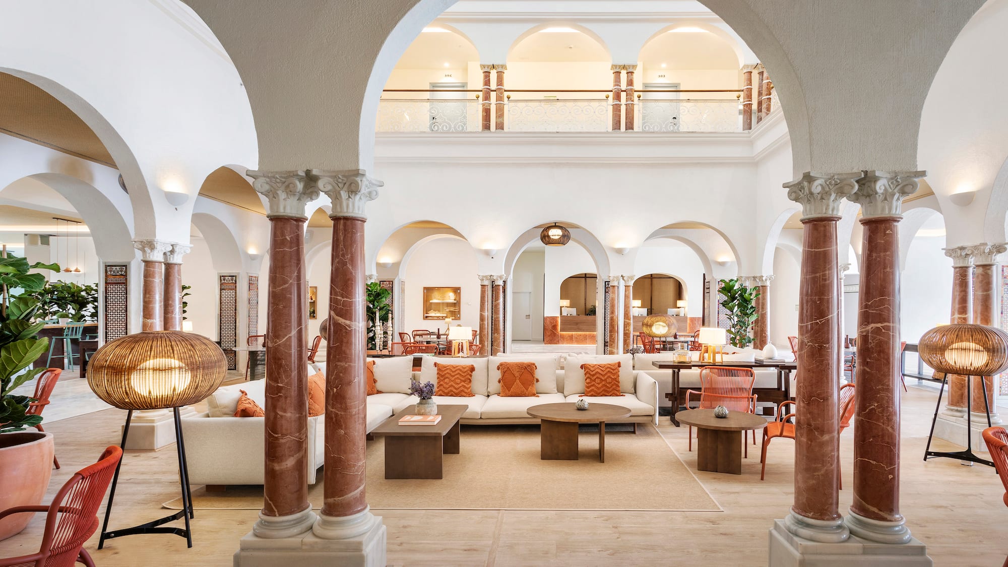 a large white room with columns and a couch