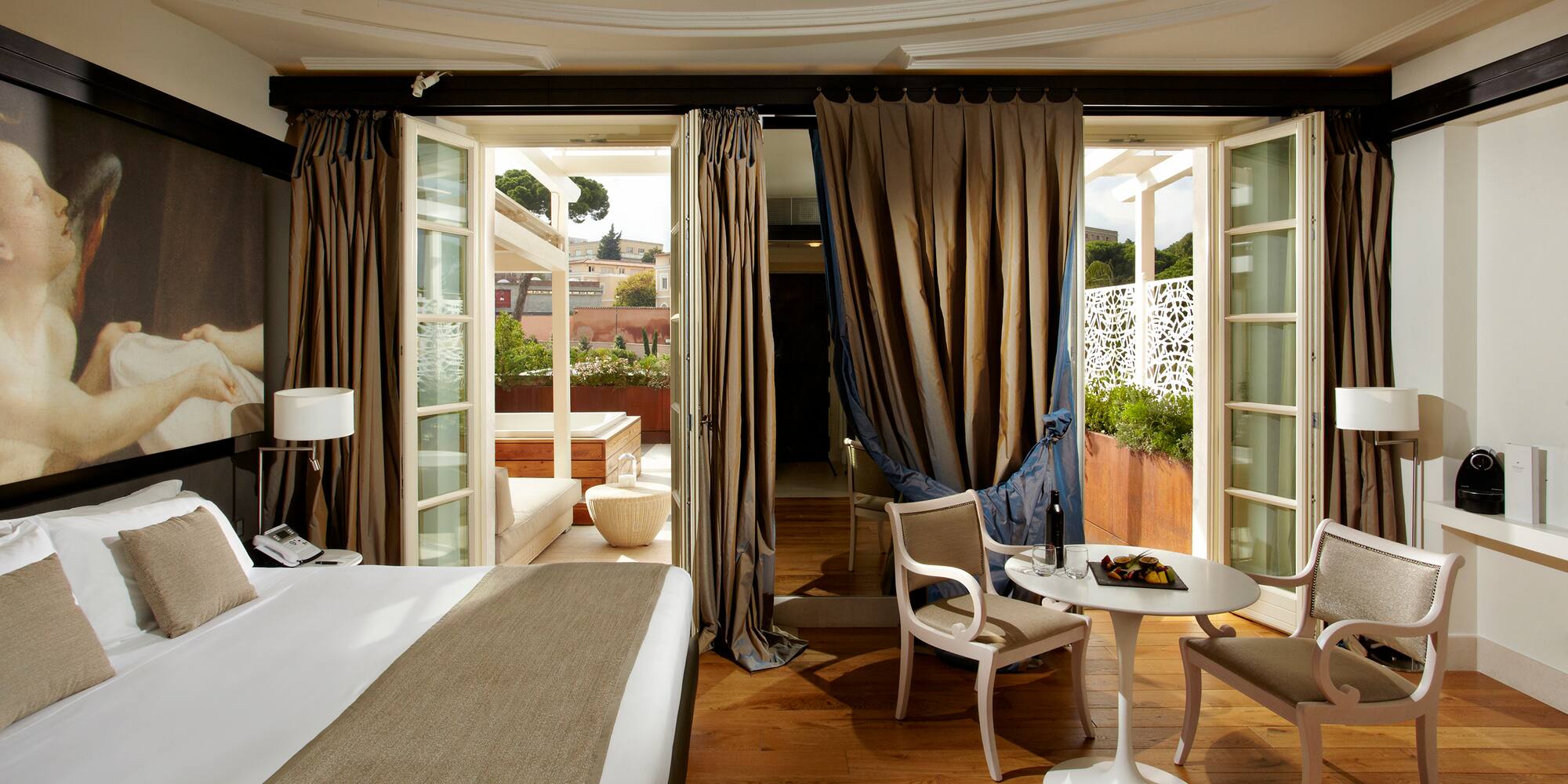 a room with a bed and chairs and a table