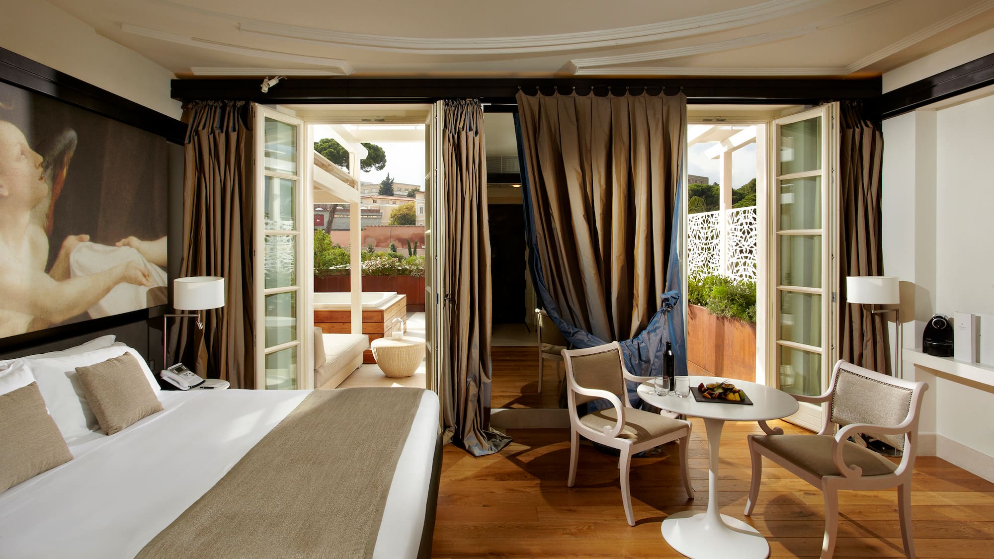 a room with a bed and chairs and a table