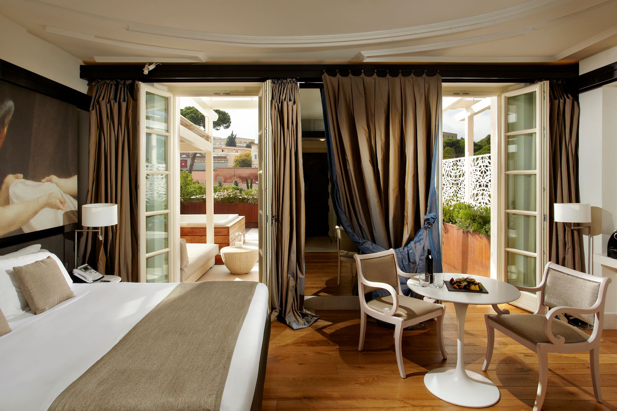 a room with a bed and chairs and a table