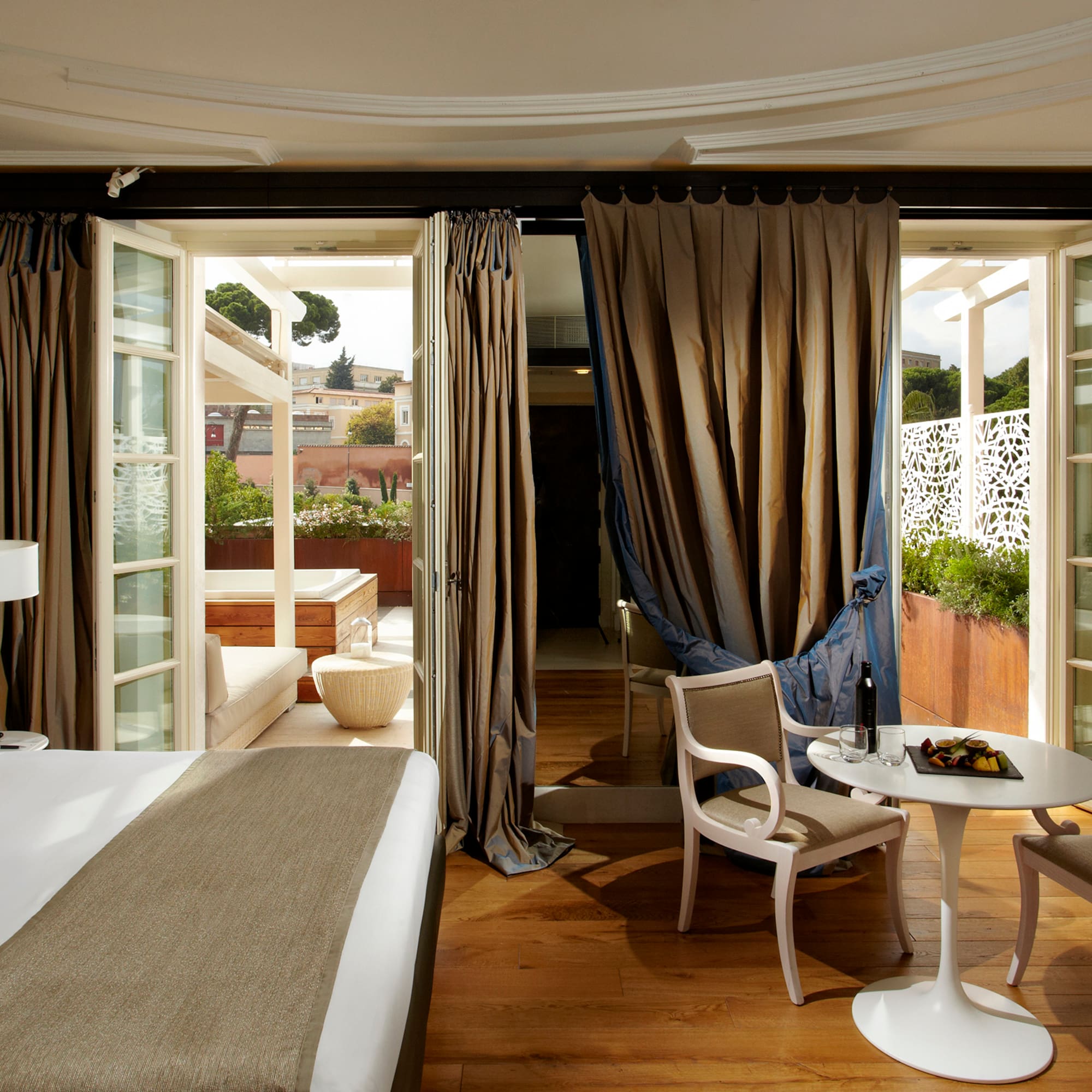 a room with a bed and chairs and a table