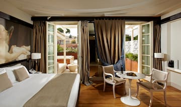 a room with a bed and chairs and a table