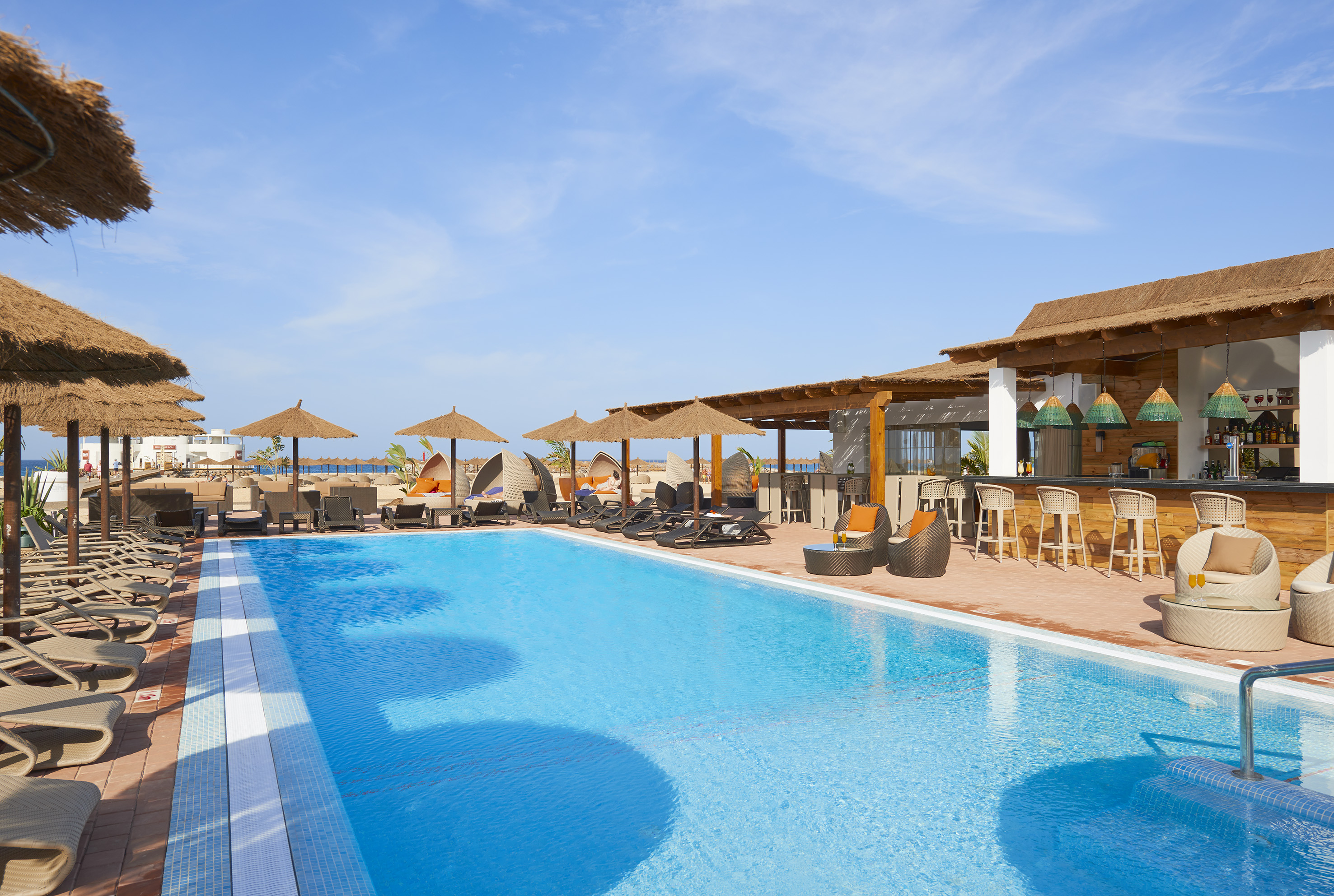 a pool with umbrellas and chairs