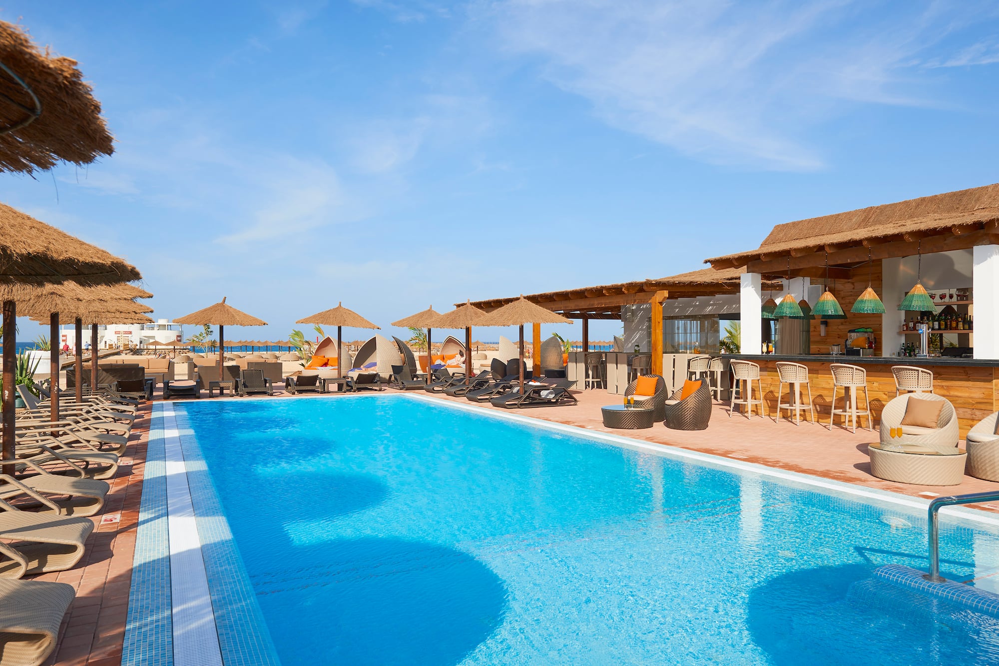 a pool with umbrellas and chairs