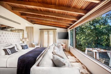 a bedroom with a large bed and a television